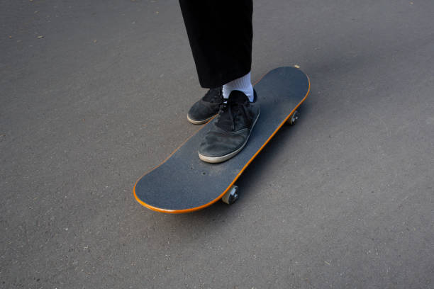 istock young man rides a skateboard in the park 1323381485