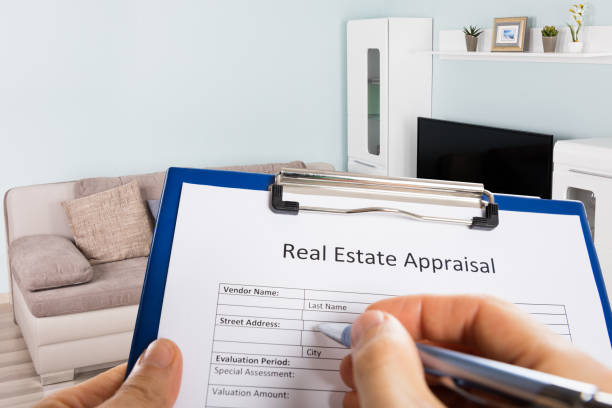 istock Person Hand Filling Real Estate Appraisal Document 1323382729