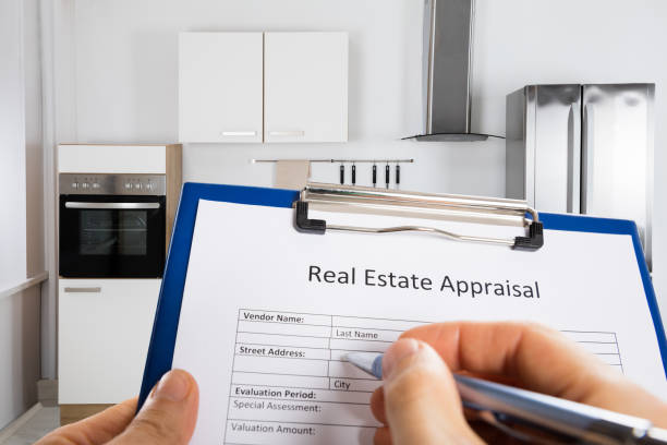 istock Person Hand Filling Real Estate Appraisal Document 1323382733