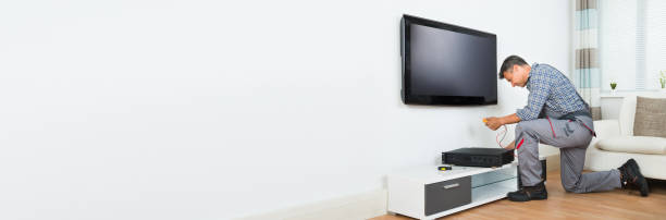istock Technician Installing TV Set Top Box At Home 1323382818