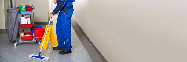 istock Janitor With Broom Cleaning Office Corridor 1323382836