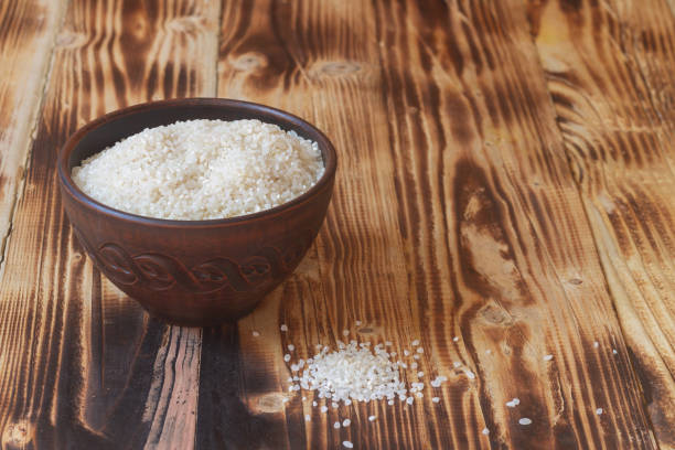 istock A brown clay bowl with round rice on a brown wooden table 1323382929