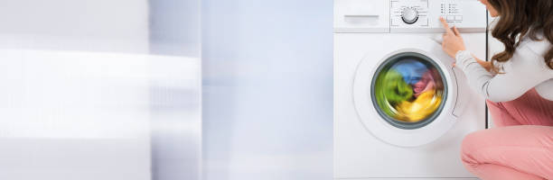 istock Woman Pressing Button Of Washing Machine 1323382981