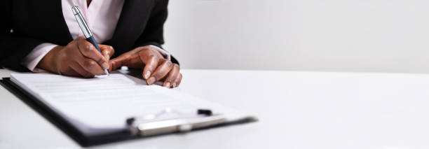 istock Woman Hands Writing On Clipboard With Pen 1323382997