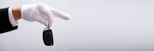 istock Valet Hand Holding Car Key 1323383044
