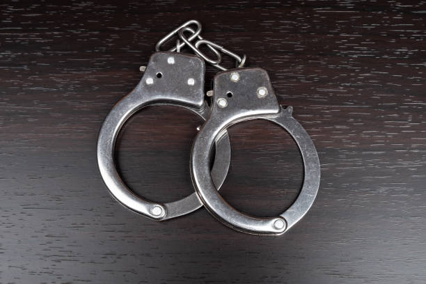 istock handcuffs on the table,arrest imprisonment 1323384828