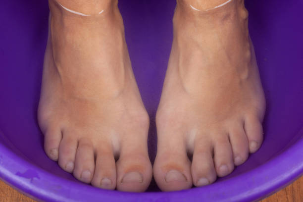 feet in hot water,foot bath closeup.