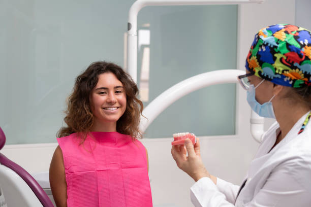 istock Girl smiling with her dentistry while showing her a splint. 1323385046