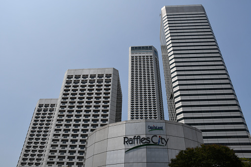 Singapore, Singapore - August 22, 2019: The Raffles City complex, designed by I. M. Pei, which includes a shopping mall, office tower, convention center and hotels.