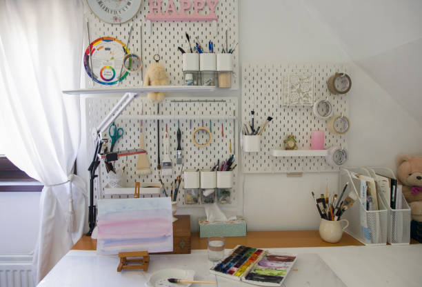 istock workplace of illustrator artist, lamp, brushes on work board 1323391329