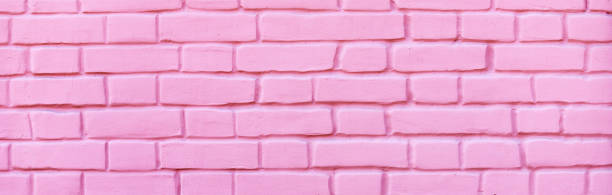 istock Texture of a brick wall coated with pink paint as a background 1323393307