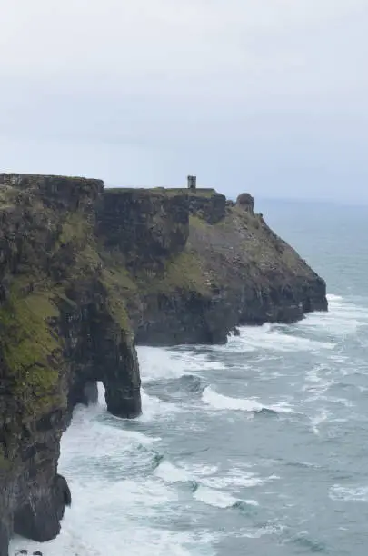 The beautiful cliffs of moher with crashing ocean waves