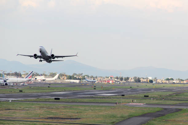 istock Plane taking off from the runway, flying through the clouds, increasing its height 1323395517