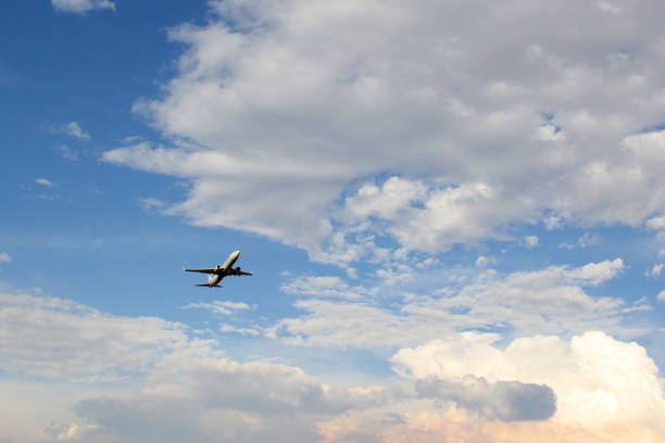 istock Plane taking off from the runway, flying through the clouds, increasing its height 1323395522