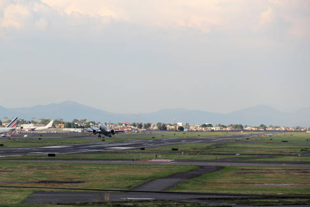 istock Plane taking off from the runway, flying through the clouds, increasing its height 1323395539