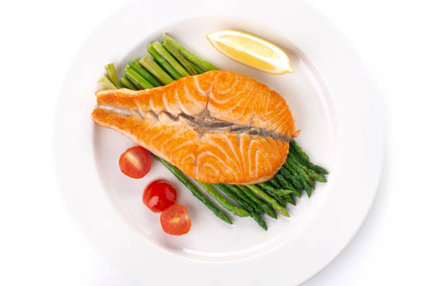 istock Grilled salmon butterfly and asparagus on a white plate, top view 1323401110