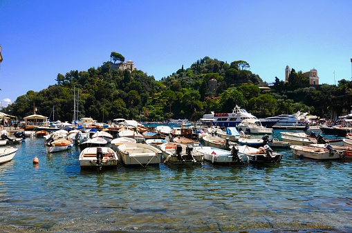 Portofino on the shore of the Gulf of La Spezia with it's harbor marina and colorfully painted town.
