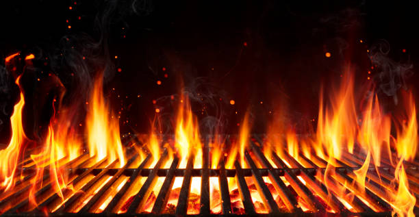 barbecue grill with fire flames - empty fire grid on black background - restaurant food color image nobody imagens e fotografias de stock