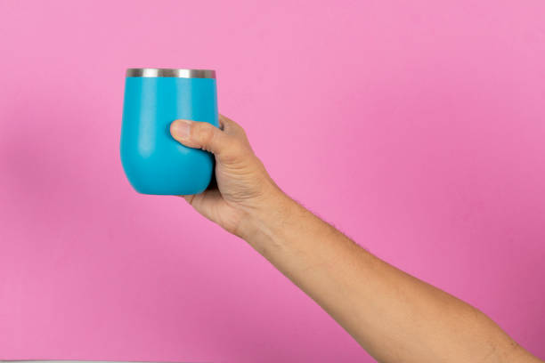 istock male hand holding a blue mug 1323406700