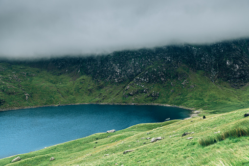 Beautiful landscape panorama of Miners Tack in Snowdonia National Park in North Wales, UK. Shoot during gloomy cloudy day with strong fog when you can't see the summit