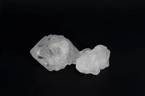 White Alum crystal isolated on black background