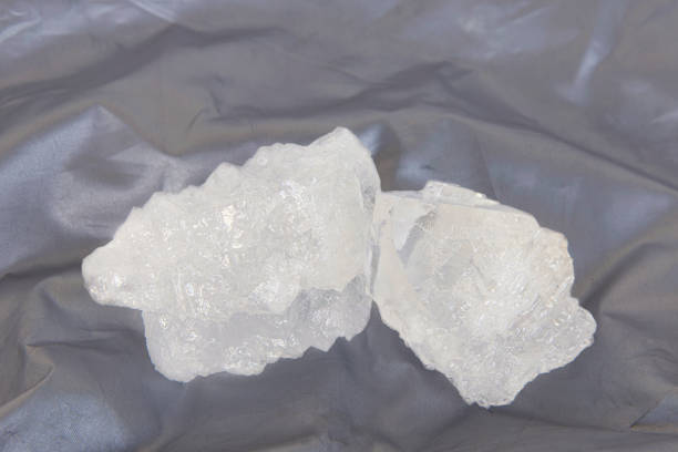istock White crystal alum stone or Potassium alum. 1323418395
