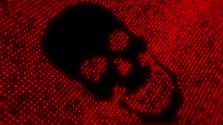 Computer virus code on a screen with a skull malware attack