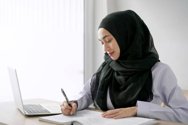 istock Young muslim student writing and learning in the room. E-learning online education. 1323420944