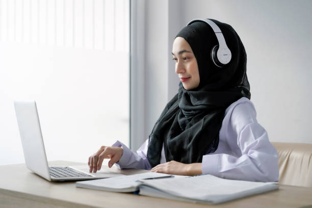 istock Young muslim student writing and learning  in the room. E-learning online education. 1323420949