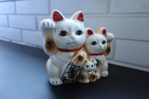 istock A white Japanese figurine cat beckoning 1323421728