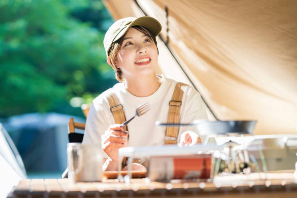 Solo camp image-A young woman relaxing in a tent
