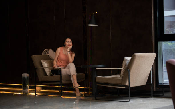 Happy freelance woman is relaxing on comfortable couch and using laptop at home.communicates on Internet with customer.