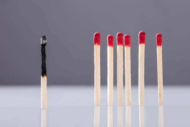 istock Burnt Matchstick Separated By Red Matchsticks 1323434027