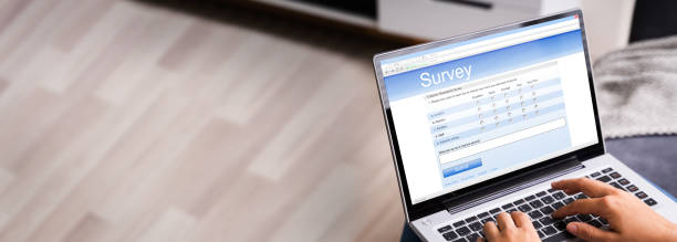 istock Woman Looking At Online Survey Laptop Computer 1323434105