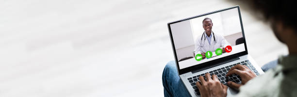 istock Man Video Conferencing With Doctor On Laptop 1323434117