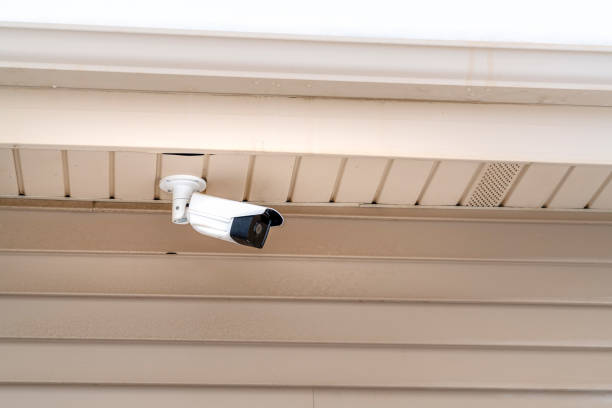 istock Exterior of building with installed bullet type surveillance camera for security 1323434159