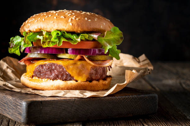 istock Cheeseburger Burger Patty classic on rustic board of wood 1323442390