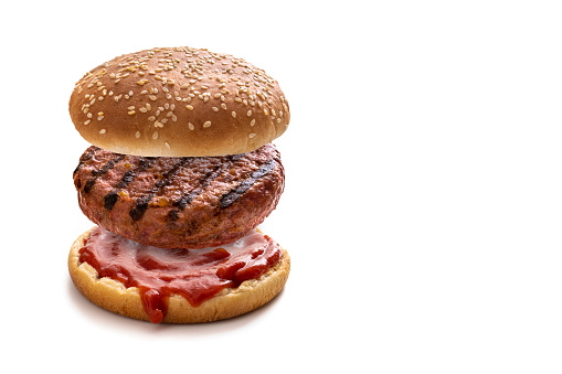 Burger concept with bun grilled meat hamburger and ketchup sauce open bun isolated on white background