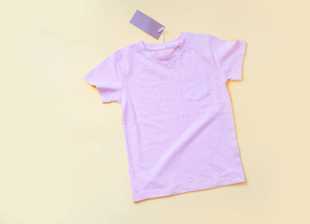 istock Empty pink T-shirt  on the yellow background 1323443163