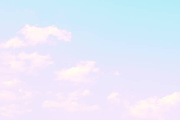 istock Beautiful pink and blue gradient sky and fluffy cloud background 1323443382