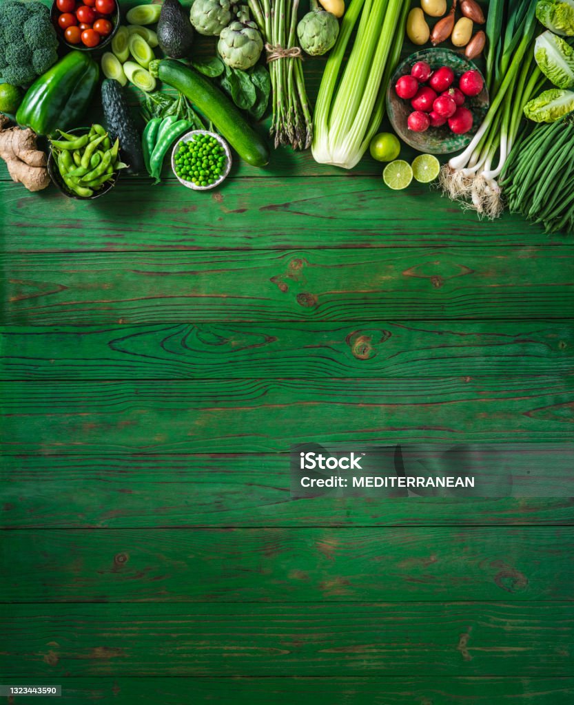 Vegan vegetables on green wooden table copy space Vegan raw vegetables on green wooden table copy space background Healthy Eating Stock Photo