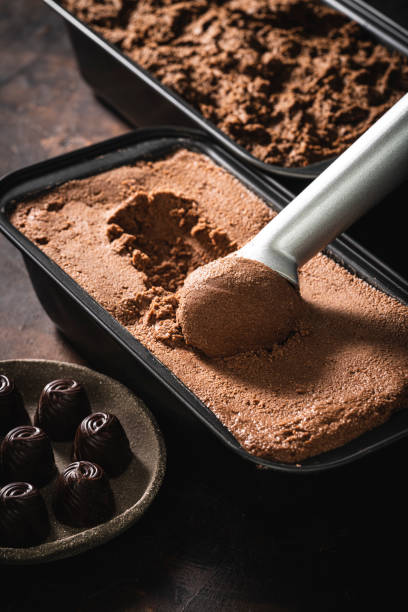 istock Chocolate ice cream scoop ball serving and chocolates macro close-up 1323443697