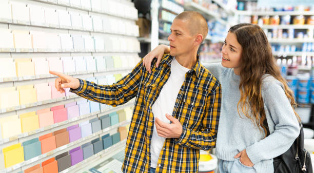 istock Woman and man consumer choosing tiles color samples in hardware store 1323443717
