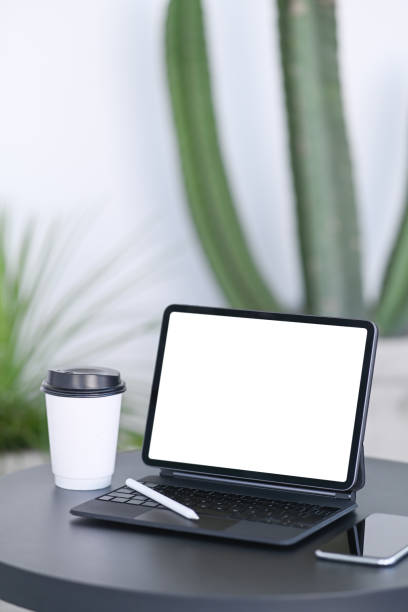 istock Computer tablet, smart phone and coffee cup on black wooden desk. 1323443765