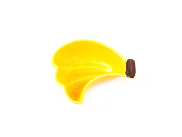 istock Empty yellow banana-shape ceramic plate isolated on a white background. Use for home or restaurant, food design. Kitchen accessory. 1323447786