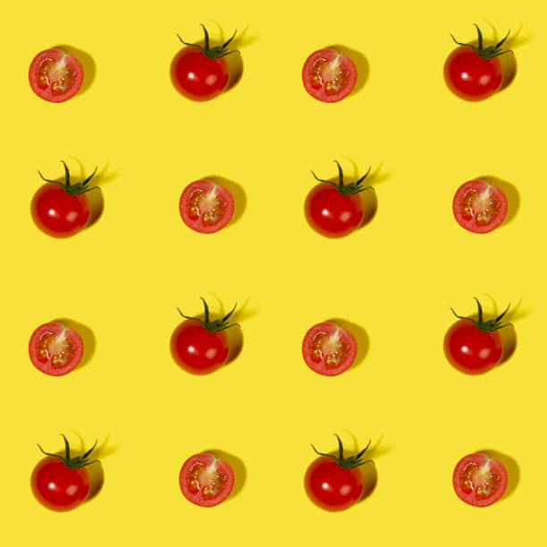 istock Vegetable colorful seamless pattern - ripe cherry tomato whole and halves with shadow on yellow background top view, square. 1323453399
