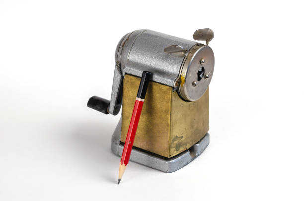 istock Wooden pencil and vintage sharpener on white background. Manual metal tool for sharpening wooden pencils. 1323456474