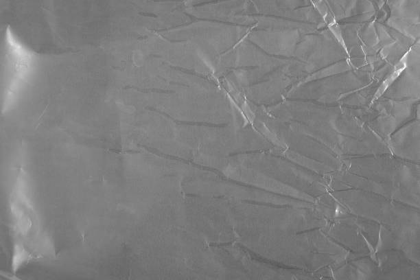 istock Gray crumpled shiny surface. Shot Of Gray Packing Texture. 1323456537