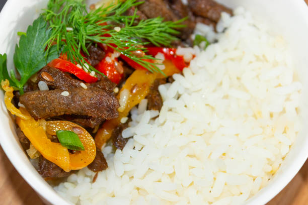 istock Roast beef with sweet pepper and white rice. Close up 1323456666