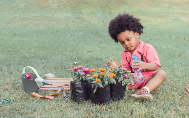 istock African boy is playing in the garden 1323458167